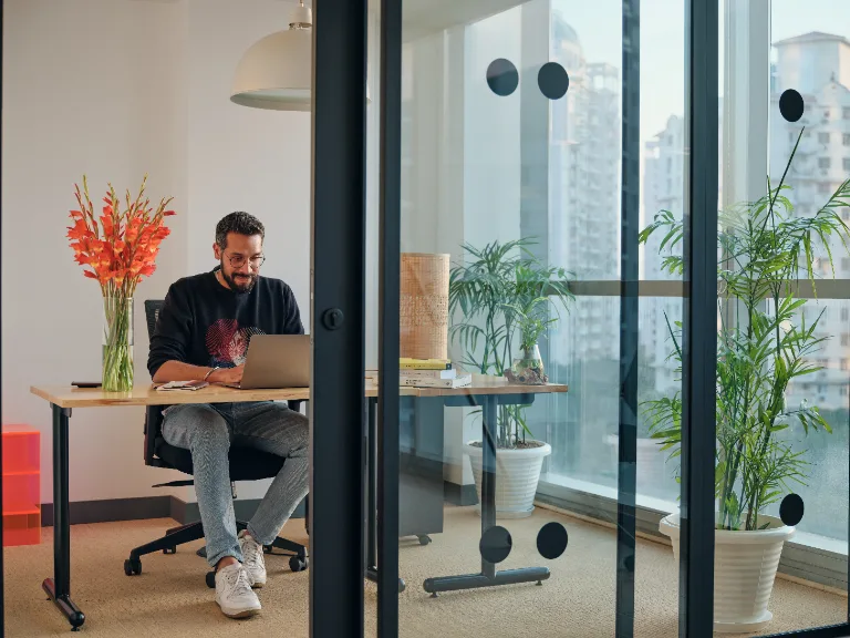 Open workspace with desks by the windows