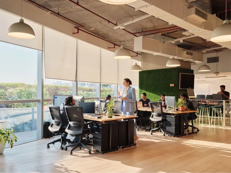 Open workspace with desks by the windows